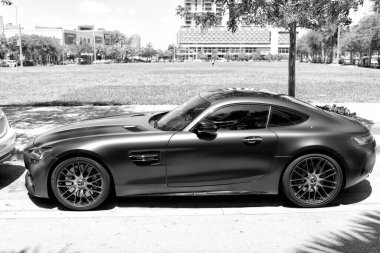 Miami Beach, Florida USA - April 15, 2021: matte mercedes benz v8 biturbo, side view high angle. clipart