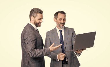 İki iş adamının dizüstü bilgisayar kullanarak serbest çalışmasına sevindim. Serbest çalışan iş adamları beyaz arka planda izole edilmiş. Stüdyoda serbest çalışan iş adamları. İş adamlarının dizüstü bilgisayarda serbest çalışmalarının fotoğrafı.