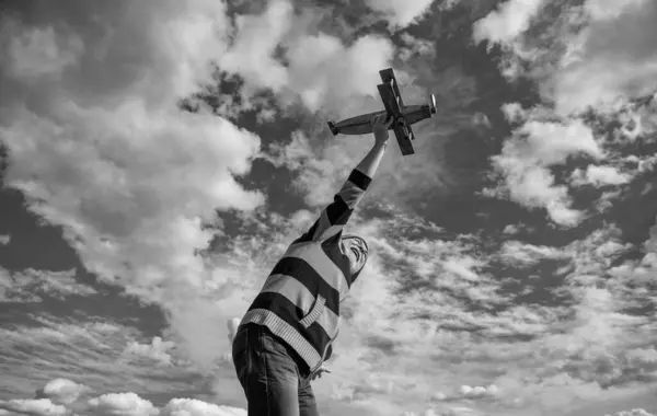 stock image retirement of senior man on sky background. senior man at retirement. senior retired man with toy plane outdoor.