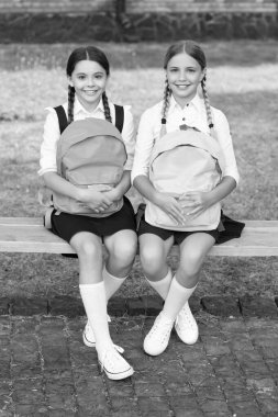 back to school. two cheerful teen children after school outdoor. friendship of school girls.