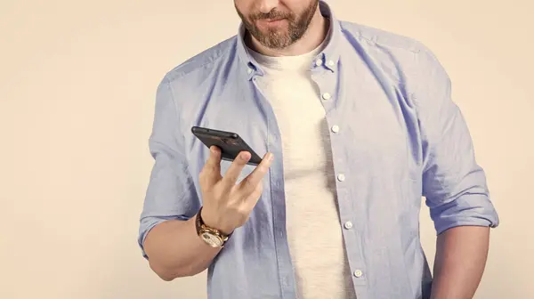 stock image message on man phone, cropped view. photo of man texting phone message. man write message on phone isolated on studio background. man with phone message in studio.