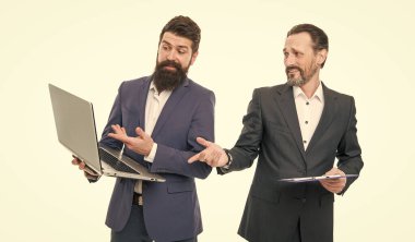 Running small Internet business. Bearded men send e-mail via computer. Internet electronic communication. Businessmen work online. Information network. Connected to Internet through office network.