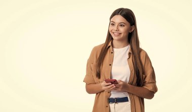 cheerful teen girl blogging on blog. teen girl has blog for blogging in studio. photo of teen girl blogging on phone blog. teen girl blogging in blog isolated on white background.