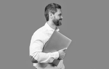 smiling businessman freelance with computer. businessman freelance holding laptop. businessman freelance isolated on blue background. businessman freelance in studio.