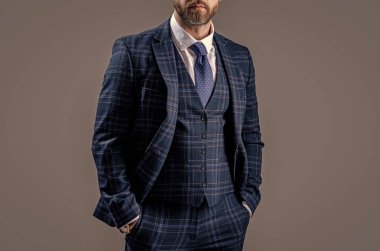 boss wearing formalwear in studio. photo of boss wear formalwear. boss in formalwear suit. boss in formalwear isolated on grey background.