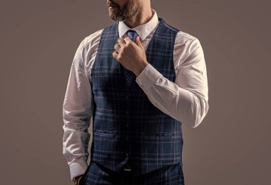 businessman in formalwear isolated on grey studio background. businessman wearing formalwear in studio. photo of businessman wear formalwear. businessman in formalwear suit.