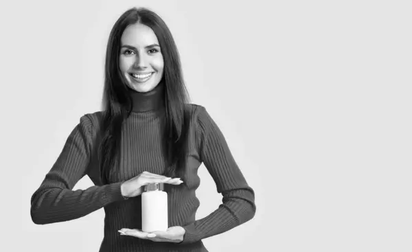 stock image woman with vitamin medication isolated on white, copy space. woman with vitamin medication in studio. woman with vitamin medication on background. photo of woman with vitamin medication jar.