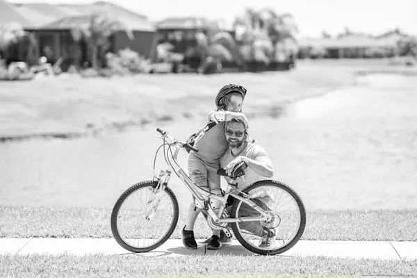 stock image active father setting a example for fathers son. fathers parenting with son outdoor. childhood of son supported by fathers care. father and son on bicycle at fathers day. Dad and kid adventures.