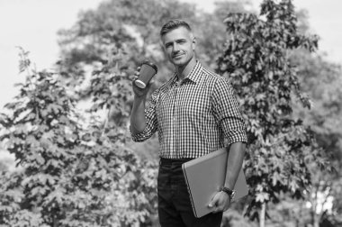 man with coffee. man freelancer drinking coffee outdoor. business man has coffee break.