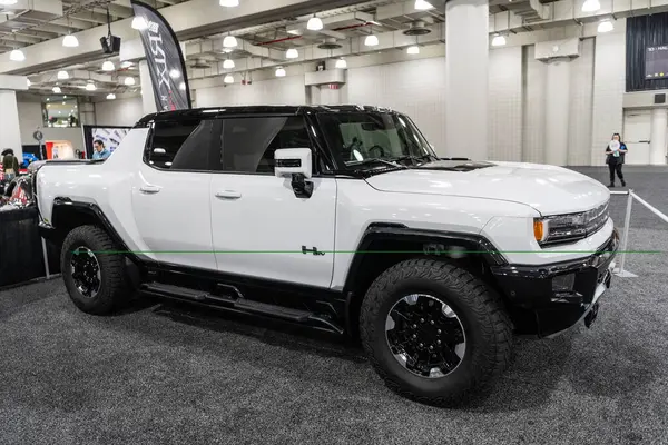 stock image New York City, USA - March 27, 2024: GMC Hummer EV pickup truck car at New York International Auto Show, side view.