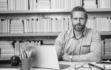 Okulda öğretmenle çevrimiçi eğitim almak sınıfta dizüstü bilgisayarla..