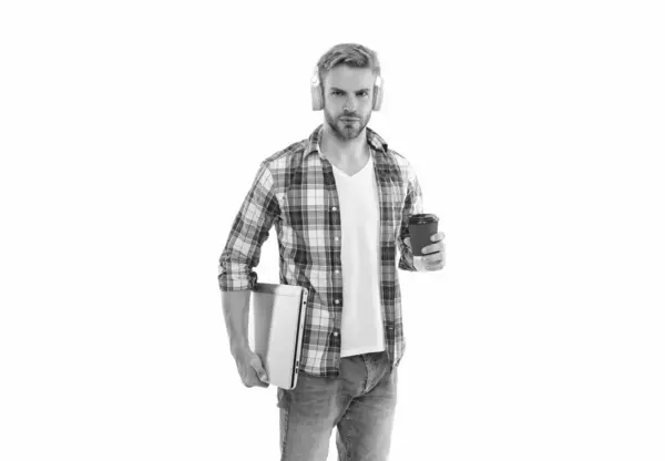 stock image millennial man student holding coffee on background. millennial man student in studio. photo of millennial man student with laptop. millennial man student isolated on white.