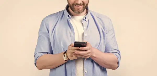 stock image cropped photo of man texting phone message. man write message on phone isolated on studio background. man with phone message in studio. message on man phone.