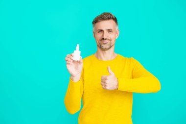 Rhinitis. İlaç ve sağlık hizmetleri. Tıbbi sprey ya da damla. Burun ya da göz tedavisi gören bir adam. Burun spreyi sunan bir adam. Burun sulama. Burun akıntısı tedavisi. Başparmak yukarı..