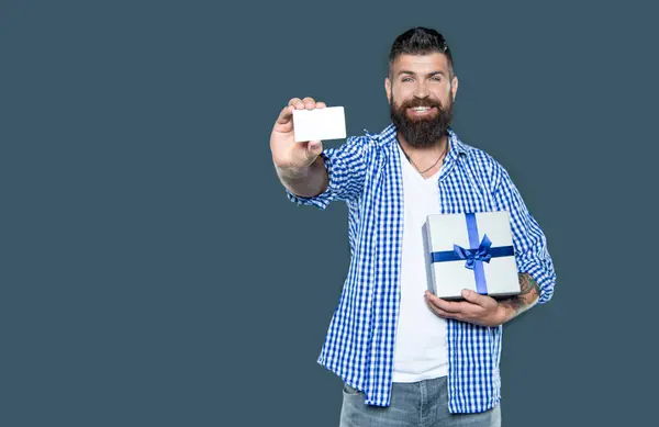 stock image mature bearded man with present box and card. selective focus.