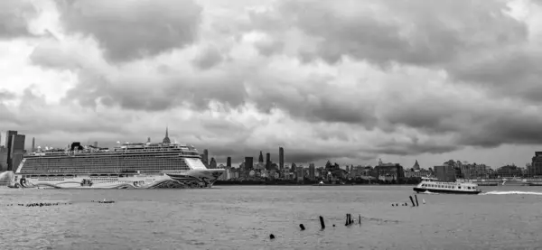 stock image New York, USA - July11, 2023: Cruise ship Norwegian Joy Sailing next to Manhattan in New York. Skyline of New York Manhattan cruising on the Hudson River cruise liner NCL.