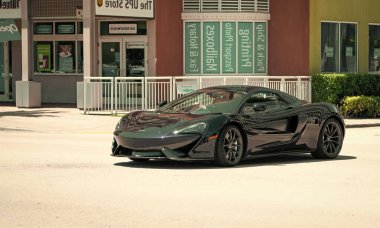 Miami Beach, Florida USA - April 15, 2021: mclaren 570GT MSO Black Collection, front corner view.