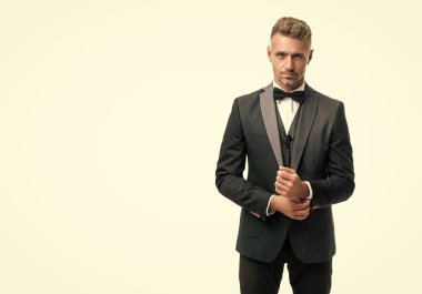 handsome man in bow tie suit. businessman isolated on white. gentleman in formal wear. copy space.
