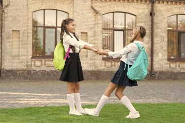 two school girls friends have fun together outdoor.
