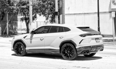 Miami Beach, Florida USA - April 15, 2021: 2019 Yellow Giallo Auge Lamborghini Urus, back corner view.