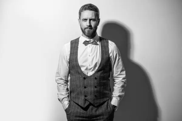 stock image man wear tuxedo formal suit. man in tuxedo on grey background. tuxedo man in studio. photo of man wearing tuxedo.