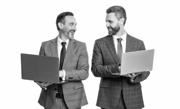 stock image happy businessmen freelance in studio. photo of businessmen freelance with laptop. two businessmen freelance using laptop. businessmen freelance isolated on white background.