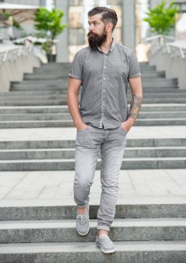 bearded guy walk downstairs. full length of guy with beard. caucasian guy outdoor.