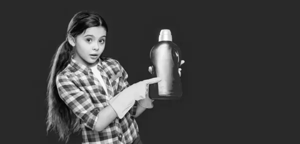 stock image girl household with detergent in studio, copy space. girl household with detergent on background. photo of girl household with detergent. girl household with detergent isolated on red.