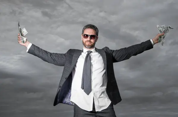 successful billionaire man with money on sky background. billionaire man with money outdoor. billionaire man with money in suit. photo of billionaire man with money.