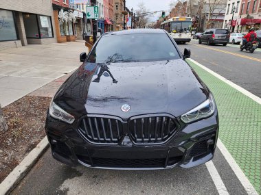 New York City, ABD - 10 Mart 2024: BMW X6 araba siyah açık hava, üst ön manzara.