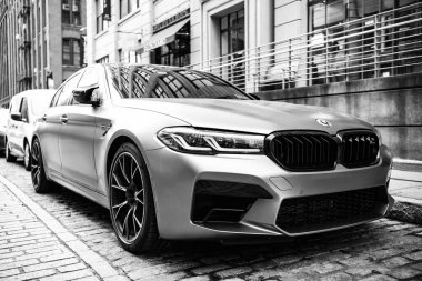 New York, ABD - 15 Temmuz 2023: BMW F90 M5 gri renkli araç park edilmiş, köşe manzaralı.