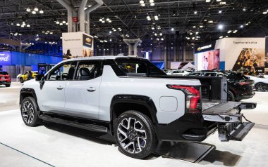 New York City, USA - March 27, 2024: 2024 Chevrolet Silverado EV electric white pickup truck at New York International Auto Show exhibition, back corner view. clipart