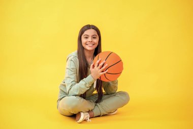 teen girl practicing basketball skills. Teen girl excelling in basketball. Skilled teen girl playing the basketball. Competitive teen girl playing basketball. Favorite childhood sports. clipart