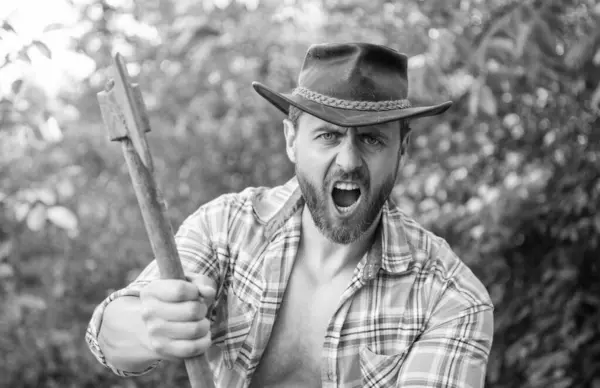 stock image image of angry lumberjack with axe. angry lumberjack with axe. angry lumberjack with axe wearing checkered shirt. angry lumberjack with axe outdoor.