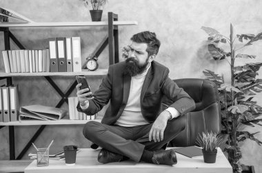 Take your SMS messaging to the next level. Serious manager read sms in smartphone. Mobile communication. Simple texting for your business.