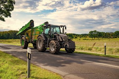 heavy machinery of tractor loader on rural road.