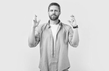 wishing man make wish with raised finger. wishing man make wish isolated on grey background. wishing man make wish in studio. photo of wishing man make wish.