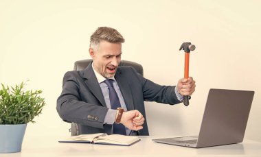 frustrated boss hitting laptop with hammer and check time. clipart