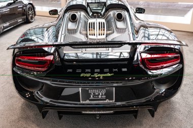 New York City, USA - March 27, 2024: 2015 Porsche 918 Spyder. Luxury Porsche 918 Spyder. Modern Porsche 918 Spyder sportscar at New York International Auto Show, rare view. clipart