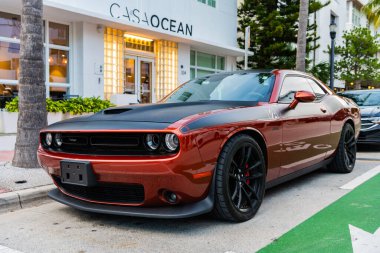 Miami Beach, Florida USA - June 9, 2024: Dodge Challenger GT at ocean drive miami beach. Dodge Challenger GT is classic muscle american car. Orange and black Dodge Challenger GT clipart