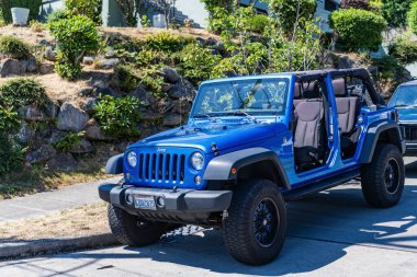 Seattle, WA, USA -July 3, 2024: jeep wrangler jk trail blue side corner view. clipart