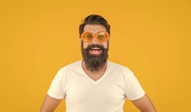 portrait photo of millennial stylish man in sunglasses. millennial stylish man isolated on yellow. millennial stylish man in studio. millennial stylish man on background. clipart