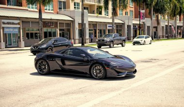 Miami Beach, Florida USA - April 15, 2021: mclaren exclusive 570GT MSO Black, side corner view.