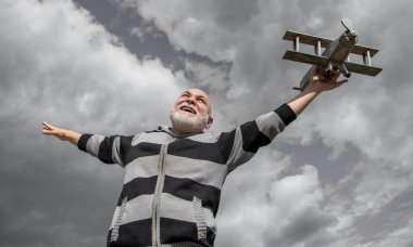 Gökyüzü geçmişindeki kıdemli adamın özgürlüğü. Emeklilikteki son sınıf. Dışarıda oyuncak uçağı olan yaşlı emekli bir adam..