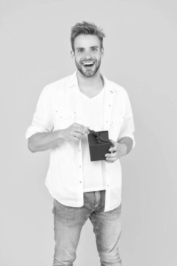 Beyazda yalnız, mutlu ve yetenekli bir adam. Stüdyoda yetenekli bir adam. Arkaplanda yeteneği olan bir adam. Hediye kutusu olan adamın fotoğrafı..