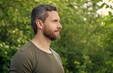 profile view of bearded man in shirt. caucasian man with beard. mature man outdoor. copy space.