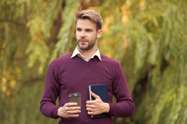 young handsome man drinking morning coffee outdoor.