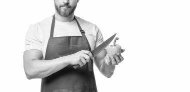 cropped view of man in apron with sweet pepper vegetable and knife isolated on white.