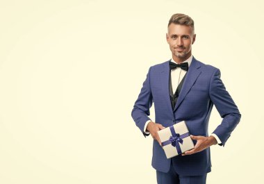 smiling mature man in suit with birthday present isolated on white.
