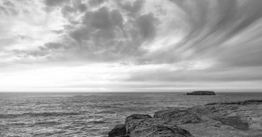 beach cliff with sea and sky in daylight.